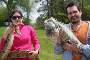 Recycled Reptiles owner Christina Gable with boa George and volunteer Daryl Leonard with Iggnatzz, an iguana, at the Parham Family Fun Day